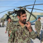 An Afghan air force expediter uses a radio to coordinate maintenance and pass status updates to the maintenance operations center Nov. 23, 2011, in Afghanistan. Maintenance advisers recently certified the first Afghan air force flight line expediter at Kandahar Air Wing. (Courtesy photo)