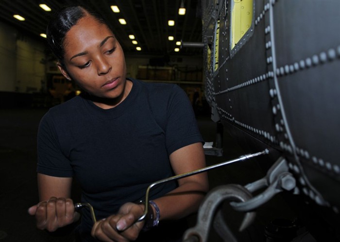 MEDITERRANEAN SEA (April 07, 2011) Aviation Ordnanceman Airman Jennifer Nunez removes a maintenance panel from a MH-60 Night Hawk helicopter in the hangar bay of amphibious assault ship USS Kearsarge (LHD 3) airspace.  Kearsarge is the command ship of Kearsarge Amphibious Ready Group supporting maritime security operations and theater security cooperation efforts in the U.S. 6th Fleet area of responsibility. (U.S. Navy photo by Mass Communication Specialist 2nd Class Joshua Mann/Released)