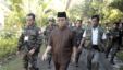 MILF leader Murad is escorted by his followers at the rebels' main camp in Camp Darapanan in southern Philippines (file photo)