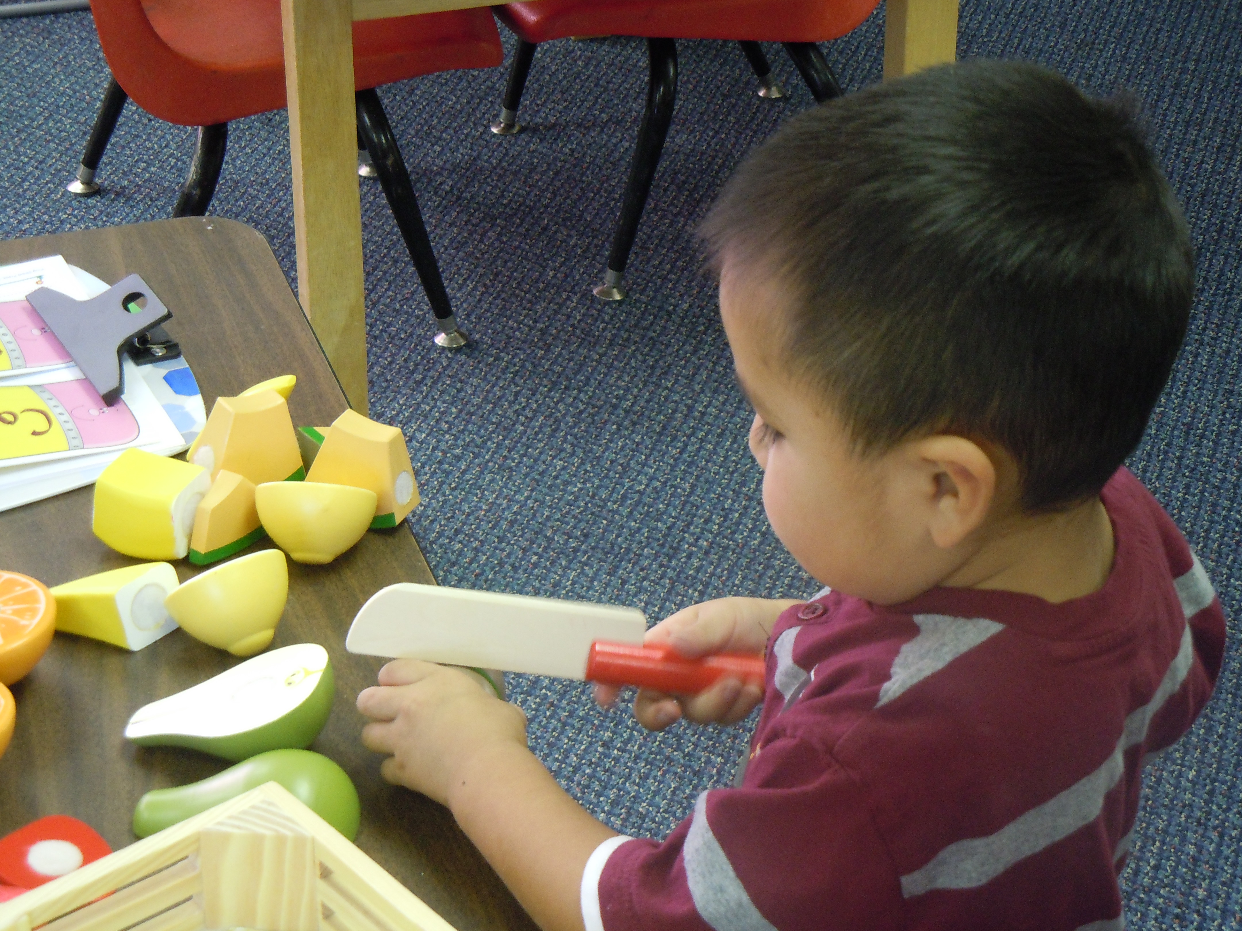 Child Slicing Fruit