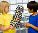 Photo of children talking about a model of a carbon nanotube.