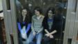 Members of the female punk band 'Pussy Riot' (L-R) Maria Alyokhina, Yekaterina Samutsevich and Nadezhda Tolokonnikova sit in a glass-walled cage before a court hearing in Moscow, October 1, 2012. 