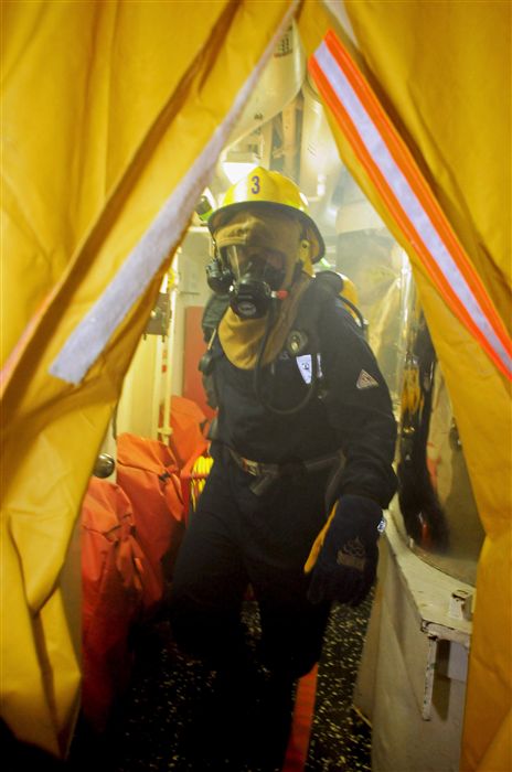 BLACK SEA (Feb. 3, 2012) - A Sailor aboard the guided-missile cruiser USS Vella Gulf (CG 72) moves quickly through a smoke curtain during a fire fighting training drill. Vella Gulf, homeported out of Norfolk, Va., is currently conducting theater security cooperation and maritime security operations in the U.S. 6th Fleet area of responsibility.