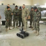 An Afghan National Army combat engineer from the 3rd/209th Route Clearance Company demonstrates robot procedures he learned from U.S. Army Sgt. Larry McClanahan (center), a combat engineer with the Embedded Training Team-3 (ETT) from the 190th Engineer Company, Task Force Roughneck, TF Sword, Jan. 24. The ETT’s goal is to train ANA operators so they can train their peers to conduct independent operations. (Photo by U.S. Army Spc. Nathaniel Mitchell)