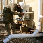 U.S. Air National Guardsman Staff Sgt. Arthur Mitchell, a civil engineer with the 577th Expeditionary Prime BEEF (Base Emergency Engineer Force) Squadron at Camp Marmal, checks a pipe of a Latrine-Shave-Shower (LSS) unit for plumbing issues. The 577th EPBS serves the role of civil engineer throughout Afghanistan and is a part of the International Security Assistance Force. ISAF Regional Command North supports Afghan National Security Forces in close coordination and collaboration in providing security and disrupting insurgent activities in order to protect the Afghan population. (Photo by U.S. Navy Lt. j.g. Cheryl Collins, RC-North Public Affairs/RELEASED)