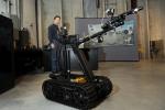 A technician at Idaho National Laboratory demonstrates the modified TALON robot.