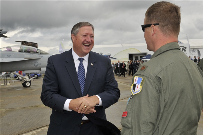 Secretary of the Air Force Michael Donley shares a laugh with Maj. Phil Johnston, 480th Fighter Squadron pilot, July 10, 2012, during a visit to the Farnborough International Air Show in Farnborough, England. Approximately 90 aircrew and support personnel from bases in Europe and the United States are participating in the air show. Participation in this premier event demonstrates that U.S. defense industry offers state-of-the-art capabilities vital for the support and protection of our Allies’ and Partners’ national-security interests.