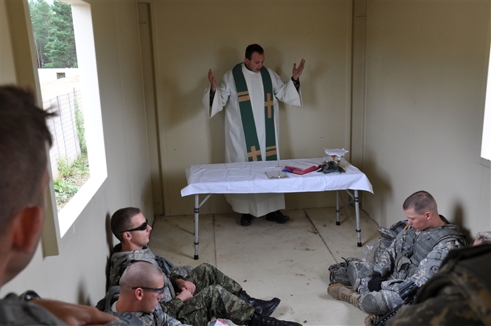 Croatian priest, Maj. Ivan Blazevac, provides mass for Soldiers on the combat outpost during the live fire portion of the first five-day tactical religious support course and live fire exercise offered by the Joint Multinational Training Command July 12. The weeklong course challenged the U.S. and NATO chaplains and chaplain assistants in approximately 45 duties and tasks required of unit ministry teams during deployment.