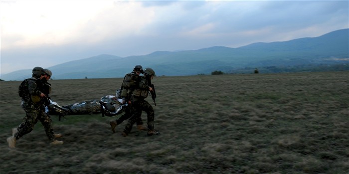 A team of multinational Special Operations Forces medics from Hungary, Croatia and Ukraine hurries across an open field to take a simulated casualty to an awaiting aircraft during a Field Training Exercise as part of the Tactical Combat Casualty Care (TCCC) course held in Udbina, Croatia. 
U.S. Special Operations Command Europe (SOCEUR) developed and conducted the TCCC Train-the-Trainer course to enhance the SOF capability and interoperability of SOF medics from eight NATO and partner nations, but most importantly, to incorporate one recognized standard for managing trauma on the battlefield.