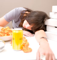 teen tired after binging on junk food