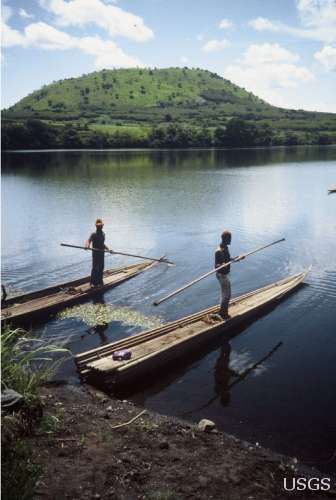 Two Cameroonian villagers prepare to sail out onto Lake Nyos, Cameroon