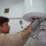 An Afghan worker makes repairs on a water heater at the Kabul Military Training Center near Kabul, Afghanistan Apr. 1.