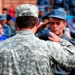 Army 2nd Lt. James Snyder, Regional Training Center–Bamyan Afghan National Police mentor team chief, returns a salute to an ANP during an ANP graduation ceremony May 19. Snyder is deployed to Afghanistan from Charlie Battery, 2nd Battalion, 44th Air Defense Artillery Regiment, Fort Campbell, Ky., in support of NATO Training Mission-- Afghanistan mission. (Air Force photo by Master Sgt. Quinton T. Burris)