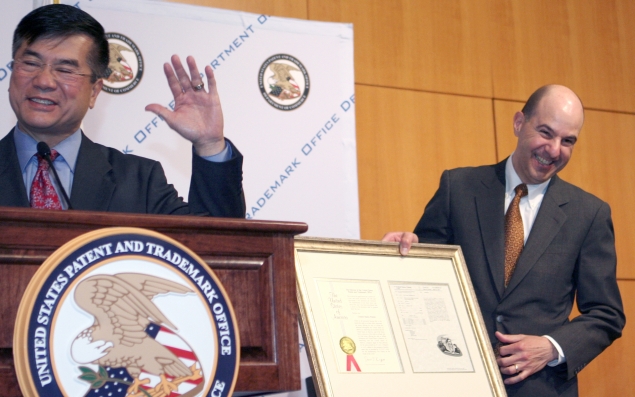 Secretary Locke and USPTO Director Kappos share a laugh over a faux patent certificate presented to the Secretary during his visit there to thank employees for their hard work in reducing the patent backlog.