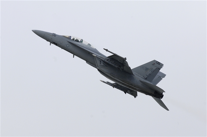 A U.S. Navy F/A-18F Super Hornet soars through the sky, July 10, 2012, during the Farnborough International Air Show in Farnborough, England. Approximately 90 aircrew and support personnel from bases in Europe and the United States are participating in the air show. Participation in this premier event demonstrates that U.S. defense industry offers state-of-the-art capabilities vital for the support and protection of our allies' and partners' national-security interests.