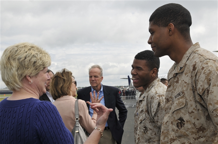 Robba Moran, wife of Kansas Sen. Jerry Moran, laughs with U.S. Marine Corps Lance Cpls. Ronte Harris and Reuben Jarmon, Marine Medium Tiltrotor Squadrons 264 and 26, July 8, 2012, during the Farnborough International Air Show in Farnborough, England. Approximately 100 aircrew and support personnel from bases in Europe and the United States are participating in the air show. The world renowned event exhibits the latest in aerospace equipment and technology.