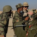 Artillery mentor Bdr Jason Pridham (right) confirms with Afghan sergeants in training at the ANA Artillery School that their gun is aimed correctly during a live-fire exercise with 122-mm D-30 howitzers.  Over Two hundred Canadian Forces advisors and support staff serve at KMTC as part of the Canadian Forces contribution to the NATO Training Mission in Afghanistan (NTM-A). (Image by MCpl Chris Ward, Canadian Forces)