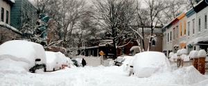 A neighborhood street covered 3 foot deep in snow