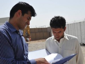 Masoud, deputy resident engineer, explains a USACE policy to Engineer Edris, a new quality assurance representative at AED-South’s Herat Area Office. 