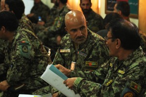 Afghan National Army Col. Hashim, the chief logistics officer for 201st Corps, discusses the Ministry of Defence request form 14 with a fellow officer during training at Forward Operating Base Gamberi, April 16. 