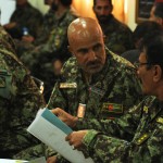 Afghan National Army Col. Hashim, the chief logistics officer for 201st Corps, discusses the Ministry of Defence request form 14 with a fellow officer during training at Forward Operating Base Gamberi, April 16.