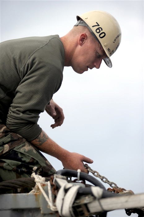 NORTH SEA (July 19, 2011) U.S. Navy Diver 1st Class Will Queen, attached with Mobile Diving and Salvage Unit (MDSU) 2, adjusts restraint chains on the standard Navy recompression chamber aboard the Military Sealift Command rescue and salvage ship, USNS Grasp (T-ARS 51). Grasp, MDSU-2 and Navy archeologist, scientist, and historians are currently deployed to the North Sea to conduct diving expeditions. (U.S. Navy Photo by Mass Communication Specialist 1st Class Ja&#39;lon A. Rhinehart/UNRELEASED)