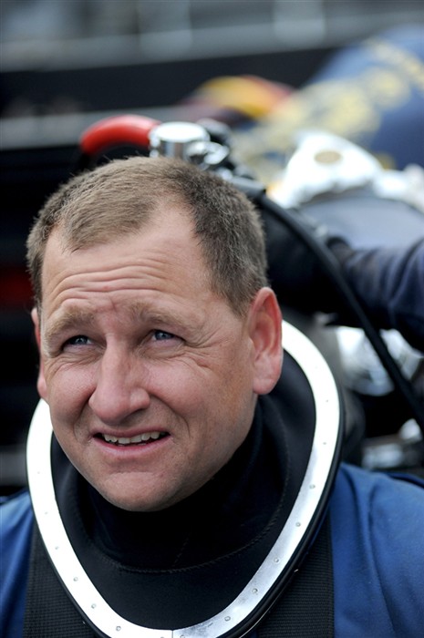 NORTH SEA (July 21, 2011) Chief Navy Diver Geoff Smitman, stationed with Mobile Diving and Salvage Unit (MDSU) 2, prepares to don his gear and commence dive operations from the Military Sealift Command rescue and salvage ship, USNS Grasp (T-ARS 51). Grasp, MDSU-2 and Navy archeologist, scientist, and historians are currently deployed to the North Sea to conduct diving expeditions. (U.S. Navy Photo by Mass Communication Specialist 1st Class Ja&#39;lon A. Rhinehart/RELEASED)