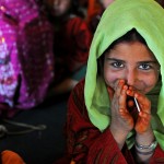 A young Afghan girl smiles shyly after being given a lollipop by an Afghan Local Policeman during a break from her lessons at the Camp 3 school in the internally displaced persons village in Task Force Spartan's area of operations Nov. 17. (Photo/U.S. Army Sgt. Amanda M. Hils)