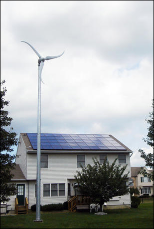 A photo of Southwest Windpower's Skystream wind turbine in front of a home. PIX14936