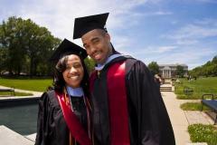 Two students smiling on graduation day