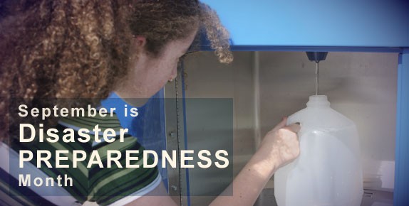 Girl filling gallon containter of water