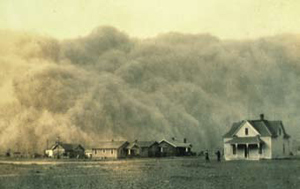 Historical photograph of large dust clouds engulfing homes.