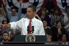Screen capture image of White House video showing Obama with students and faculty behind him.