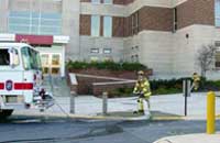 (Fig. 1.3) During initial operation at this structure, the first arriving engine crew is already using a fire lane, a fire hydrant, the fire department connection, and the key box. Interior operation will soon involve the alarm system, stairways, standpipe system, and other building features.