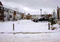 (Fig. 2.7) The same paver block access lane as shown in figure 2.6, but covered with snow.  Access is blocked by a mound of snow plowed from the adjacent parking lot.