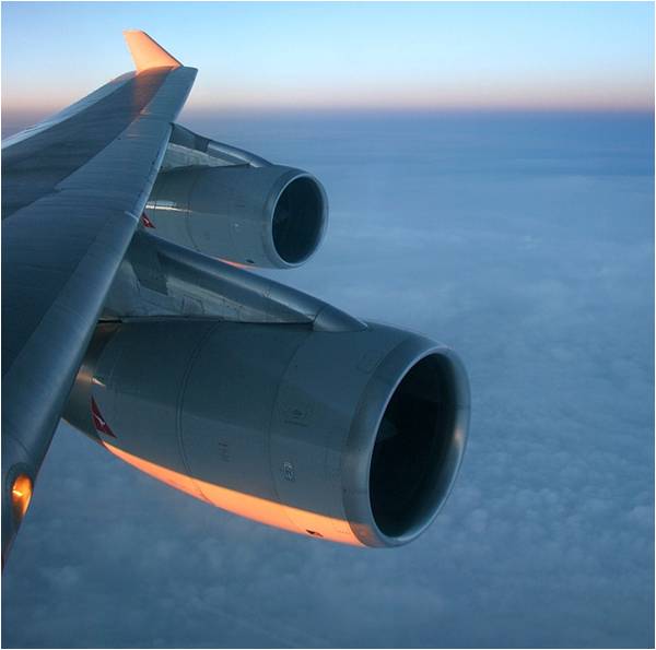 Window view of aircraft wing in flight