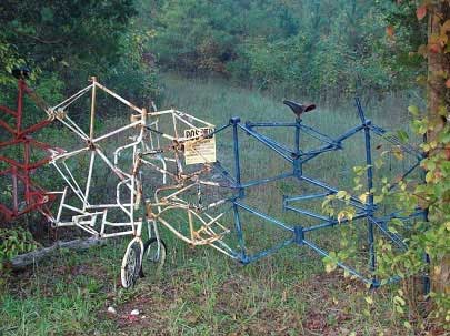 Photo of a fence made out of twisted bicycles.