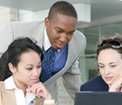 3 people viewing a monitor