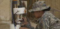 Soldier works with portable air sampler