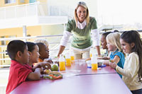 Photo: teacher and kids in school cafeteria