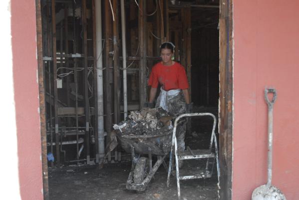 volunteer moves debris