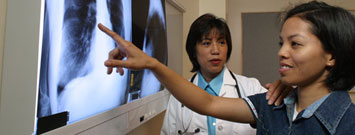 photo of 2 women looking at xrays