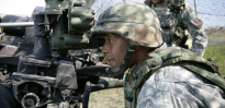 U.S. Army Field Artillery Sergeant Sibert verifying adjustments
