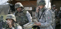 U.S. Army Field Artillery Soldiers adjusting M119