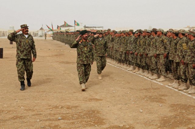 Col. Mohammad Haroon (left), Regional Military Training Center-Kandahar commander and Maj. Gen. Abdul Hamid (front), 205th Hero Corp commander, inspect Afghan National Army soldiers at the RMTC-K graduation ceremony at Camp Hero, Afghanistan, Sept. 13, 2012. The center graduated more than 1,000 soldiers at the ceremony from both the basic training course and the officer basic course.