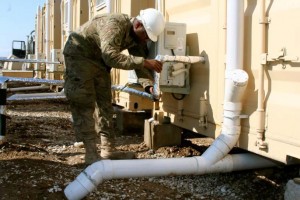 U.S. Air National Guardsman Staff Sgt. Arthur Mitchell, a civil engineer with the 577th Expeditionary Prime BEEF (Base Emergency Engineer Force) Squadron at Camp Marmal, checks a pipe of a Latrine-Shave-Shower (LSS) unit for plumbing issues. The 577th EPBS serves the role of civil engineer throughout Afghanistan and is a part of the International Security Assistance Force. ISAF Regional Command North supports Afghan National Security Forces in close coordination and collaboration in providing security and disrupting insurgent activities in order to protect the Afghan population. (Photo by U.S. Navy Lt. j.g. Cheryl Collins, RC-North Public Affairs/RELEASED)