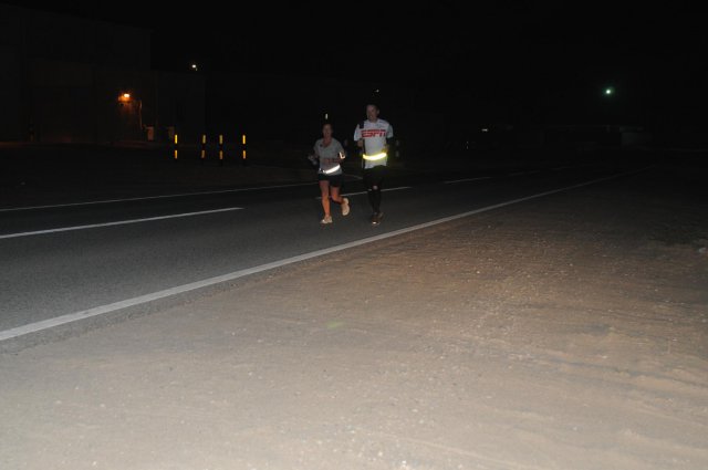 Sgt. 1st Class Rita Rice, left, ran 100 miles inside the fence line of Camp Arifjan, Kuwait, in just over 24 hours, April 1, 2012. Each lap around the base was approximately seven miles. She dedicated her race to fallen comrades from North Carolina. A fellow 113th Sustainment Brigade Soldier, Sgt. 1st Class Lee Klimala, runs a few laps with Rice.