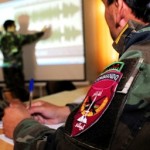 An Afghan National Army Commando public affairs officer takes notes on how to use a radio editing program during a class Oct. 31 at Camp Shaheen, near Mazar-e-Sharif, Afghanistan. The class, taught by Capt. Ahmad Javid Salim, 5th Kandak Commandos PAO, is part of a three-week course designed to teach all Kandak Commando PAOs how to operate a fully functional radio station. Once all stations are operational the commandos will broadcast information, news, and music throughout Afghanistan. (Air Force photo by Master Sgt. Kristina Newton)