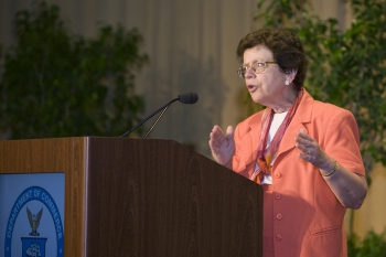 Acting Secretary Blank gestures from the dais