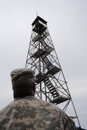 BEACON, NY -- Spc. Karlan Standford, 1156th Engineer Company, New York Army National Guard, observes Spc. Noel Polanco working at the top of the Mount beacon fire observation tower, September 7, 2012. The 1156th has stayed busy over the last year providing both military and community support ranging from aid to civilian authories during Tropical Storm Irene and Tropical Storm Lee to cleaning up the old Erie Canal.